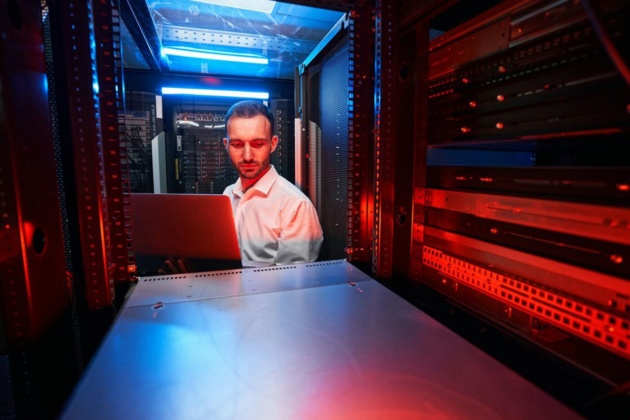 Site DT 2 caucasian it technician doing security check of server rack